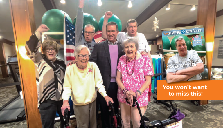 Paul Miller and residents of the Village of Westland celebrating with the cover of Your Giving Matters